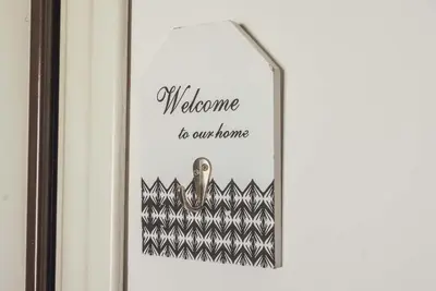 a framed picture of a welcome to our home at St Peter Vatican- Stylish Apt, Roma in Rome