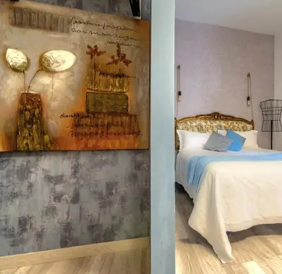 a bedroom with a bed and a painting on the wall at St Peter Vatican- Stylish Apt, Roma in Rome