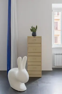 a white bunny chair in a room with a dresser at HospitalityRome Vittorio Emanuele in Rome