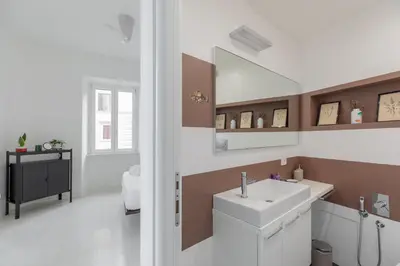a bathroom with a sink and a mirror at HospitalityRome Vittorio Emanuele in Rome