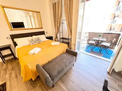 a bedroom with a bed with a chair and a mirror at Trastevere10 in Rome