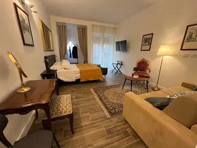 a living room with a bed and a couch at Trastevere10 in Rome