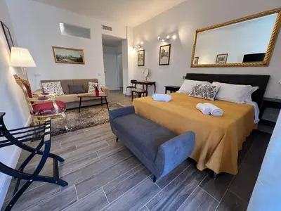 a bedroom with a large bed and a couch at Trastevere10 in Rome