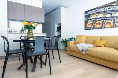 a living room with a table and a yellow couch at Colosseum Luxury suite 41 in Rome