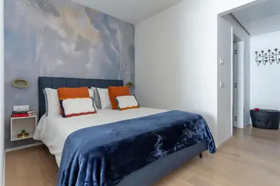 a bedroom with a large bed with orange pillows at Colosseum Luxury suite 41 in Rome