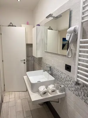 a bathroom with a sink and a mirror at Appartamento stazione trastevere in Rome