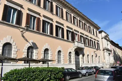 a large building with cars parked in front of it at Casa Beatrice, Trastevere in Rome