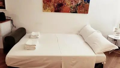 a white couch in a room with a painting on the wall at Casa Beatrice, Trastevere in Rome