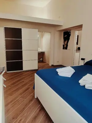 a bedroom with a large bed with a blue blanket at Casa Beatrice, Trastevere in Rome