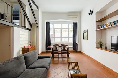 a living room with a couch and a table at Trevi Fountain - Modern Suite in 17th-century Palazzo in Rome