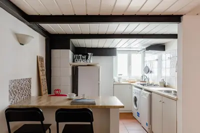 a kitchen with a table and chairs in a room at Trevi Fountain - Modern Suite in 17th-century Palazzo in Rome