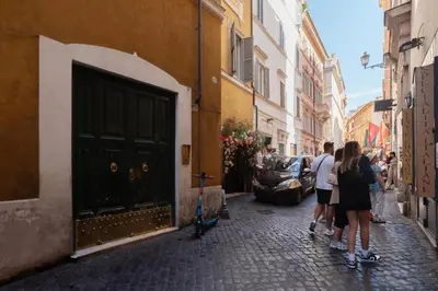 a group of people walking down a street at Trevi Fountain - Modern Suite in 17th-century Palazzo in Rome