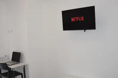 an office with a laptop and a sign that reads netflix at SWEET RETREAT - Trastevere Station in Rome