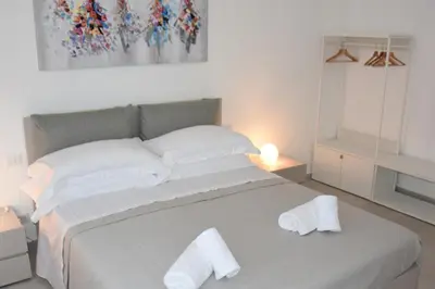 a bedroom with a large bed with towels on it at SWEET RETREAT - Trastevere Station in Rome