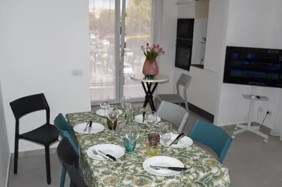 a dining room table with plates and wine glasses at SWEET RETREAT - Trastevere Station in Rome