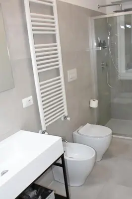 a bathroom with a toilet and a shower and a sink at SWEET RETREAT - Trastevere Station in Rome