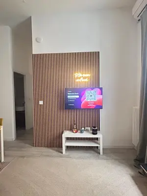 a room with a bench and a television on a wall at Leonidas house 2 in Rome