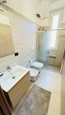 a bathroom with a sink and a toilet and a shower at Casa Alice in Rome
