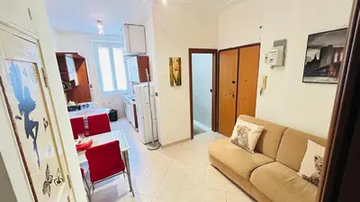 a living room with a couch and a kitchen at Casa Alice in Rome