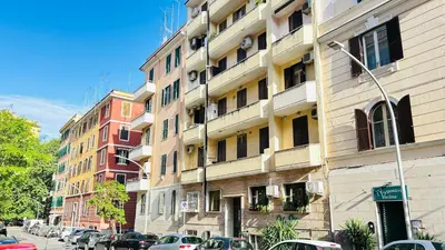 a tall building with cars parked in front of it at Casa Alice in Rome