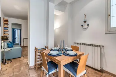 a dining room with a wooden table and chairs at La Casa di Taumasia in Rome