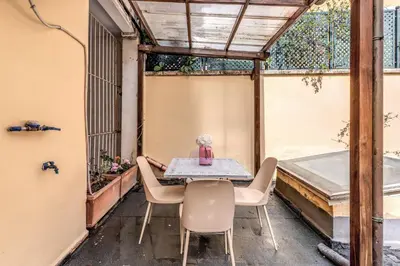 a patio with a table and chairs in a building at La Casa di Taumasia in Rome