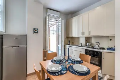 a kitchen with a wooden table with plates on it at La Casa di Taumasia in Rome