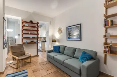 a living room with a couch and a chair at La Casa di Taumasia in Rome
