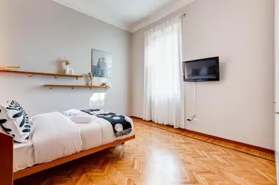 a bedroom with a bed and a flat screen tv at Terrace with a view of Rome in Rome