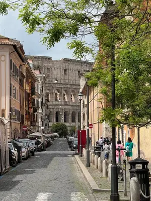 a city street with a large building in the background at Labicum XXII - Modern Luxury Studio near the Colosseum in Rome