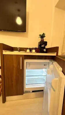 an empty refrigerator with its door open in a kitchen at Antony house in Rome