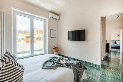 a bedroom with a bed with a television on the wall at Cipria Luxury Apartment in Rome