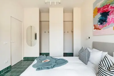 a bedroom with a bed and a painting on the wall at Cipria Luxury Apartment in Rome
