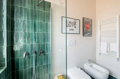 a bathroom with a shower and a toilet and a sink at Cipria Luxury Apartment in Rome