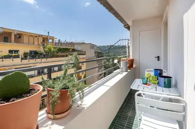 a balcony with a table and plants on it at Cipria Luxury Apartment in Rome