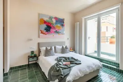 a bedroom with a bed and a large window at Cipria Luxury Apartment in Rome