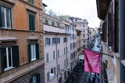 a pink flag hanging from the side of a building at Relais Monti in Rome