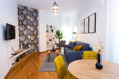 a living room with a blue couch and a table at Piazza Navona Elegant Apartment in Rome