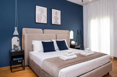a bedroom with a large bed with blue walls at Piazza Navona Elegant Apartment in Rome