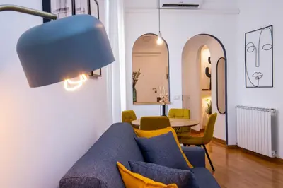 a living room with a blue couch and a table at Piazza Navona Elegant Apartment in Rome