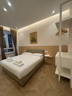 a bedroom with a large bed with towels on it at Re&x Home Rome Near Coloseum in Rome