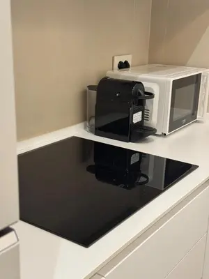 a microwave sitting on top of a kitchen counter at Re&x Home Rome Near Coloseum in Rome