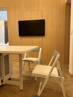 a dining room with a table and chairs and a tv at Re&x Home Rome Near Coloseum in Rome