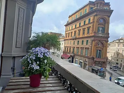 a flower pot sitting on the stairs of a building at Private room by an Italian family - A unique experience close to Colosseum, the Roman Forum and Basilica Saint Mary Major in Rome