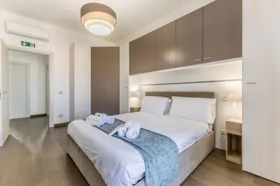 a bedroom with a large bed with towels on it at Casa Malupa Luxury Apts San Giovanni in Laterano in Rome
