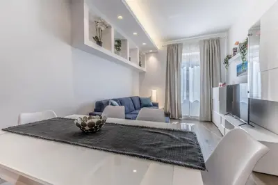 a living room with a dining table and a couch at Casa Malupa Luxury Apts San Giovanni in Laterano in Rome