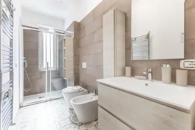 a bathroom with a toilet and a sink and a shower at Casa Malupa Luxury Apts San Giovanni in Laterano in Rome