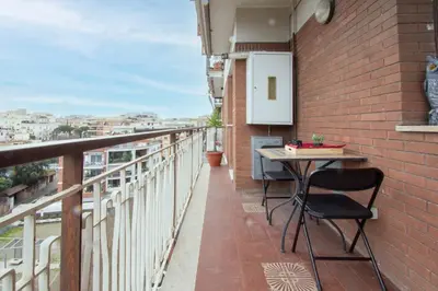 a balcony with a table on a brick wall at 8bit Dreams - Al Pigneto - 100 m da Metro Malatesta in Rome