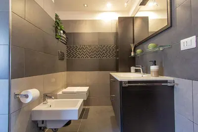 a bathroom with a sink and a toilet and a mirror at 8bit Dreams - Al Pigneto - 100 m da Metro Malatesta in Rome