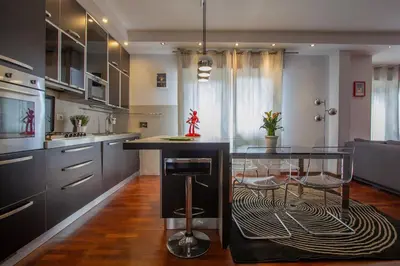 a kitchen with a glass table and a counter at 8bit Dreams - Al Pigneto - 100 m da Metro Malatesta in Rome